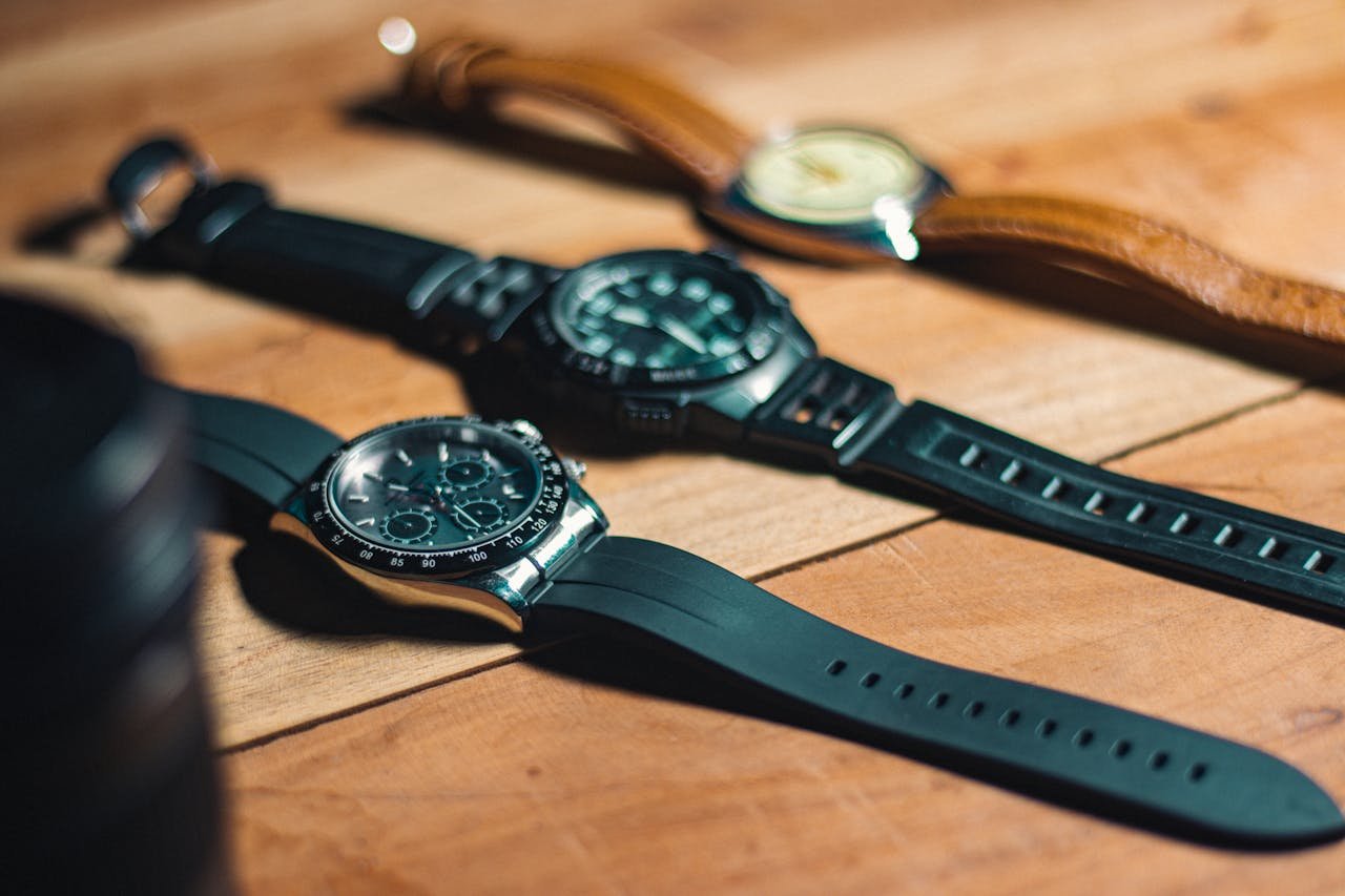 Home - Offiicial Close-up of elegant analog wristwatches on a wooden surface, showcasing style and craftsmanship.